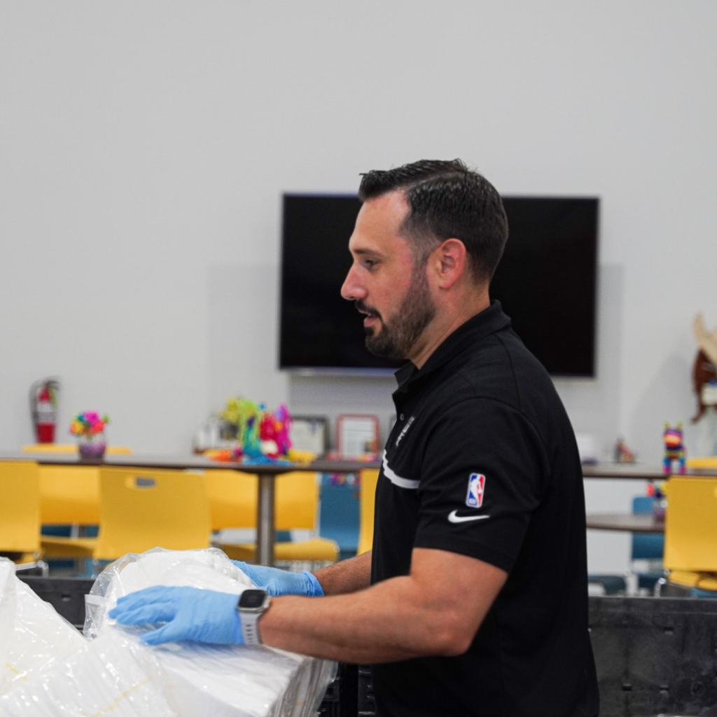 Robby Brown Volunteering with United Way on behalf of DOCUmation at the Texas Diaper Bank, in San Antonio. 